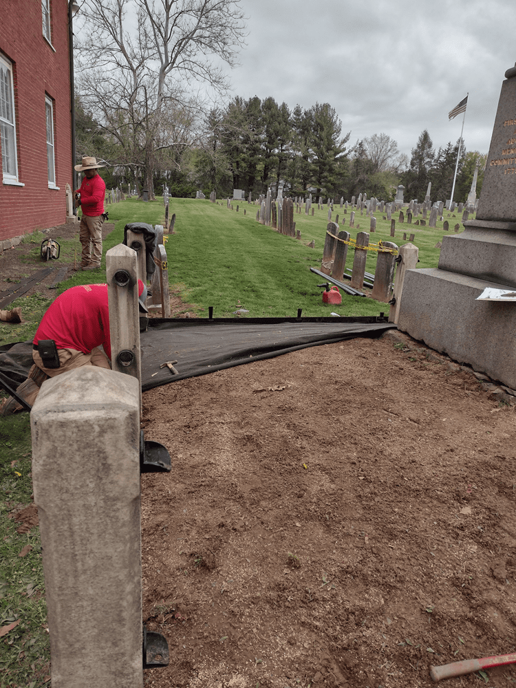 Overgrown weeds were removed and a weed barrier was installed.